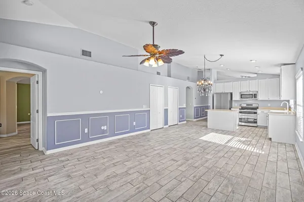 a view of a kitchen with wooden cabinet and a refrigerator