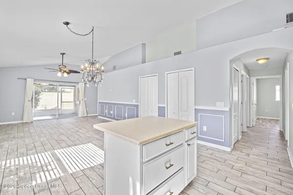 a kitchen that has a sink a stove and a table