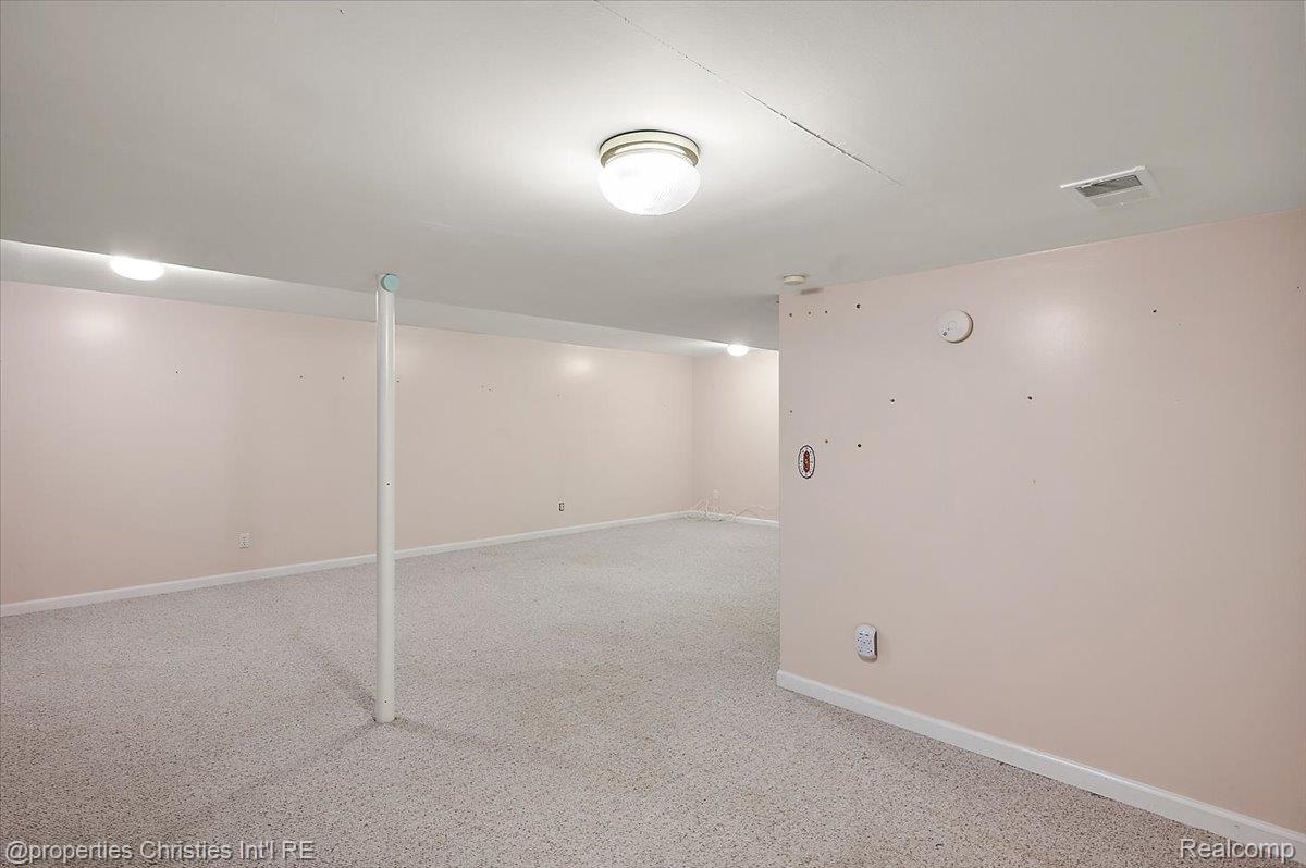 955 Rikki Ann Court Wixom, MI 48393 - Photo 52 of 54 Finished below grade area featuring light carpet and baseboards