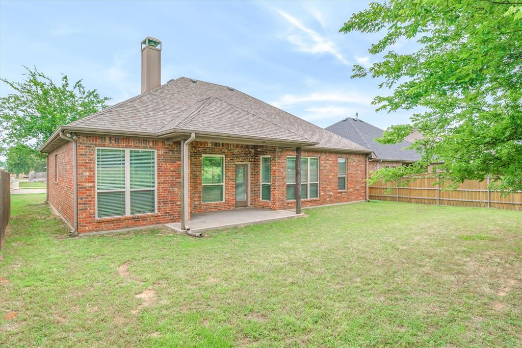 1852 Meadowview Canton, TX 75103 - Photo 24 of 28 a front view of a house with a garden and yard