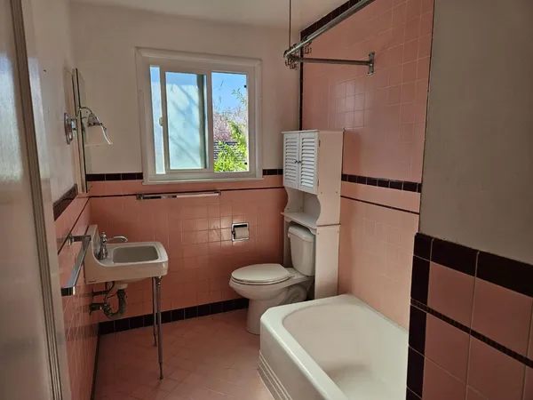 a bathroom with a sink a toilet and a shower