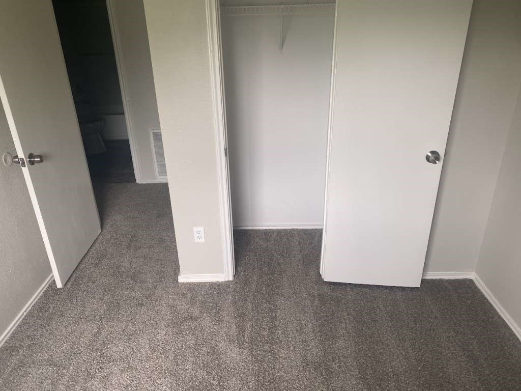 13626 Collins Street Kendleton, TX 77417 - Photo 12 of 16 an empty room with a door