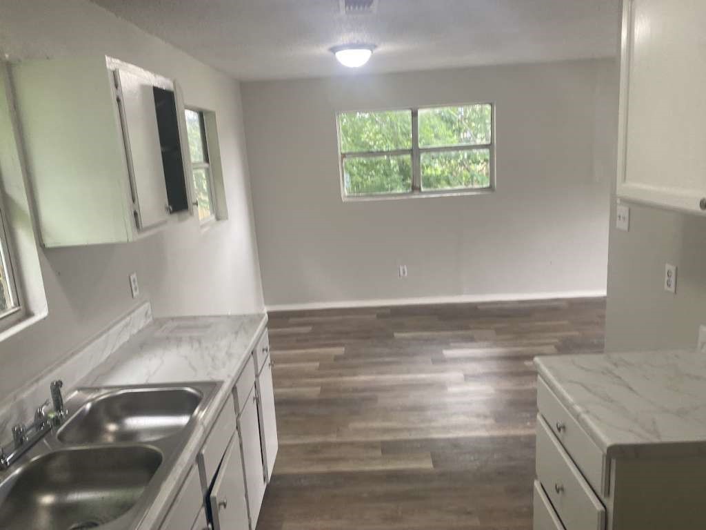 13626 Collins Street Kendleton, TX 77417 - Photo 7 of 16 a kitchen with a sink and a stove next to a window