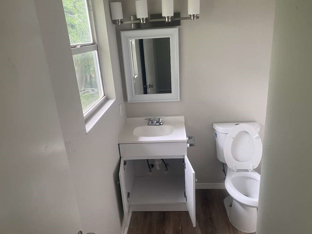 13626 Collins Street Kendleton, TX 77417 - Photo 9 of 16 a bathroom with a toilet a sink and mirror