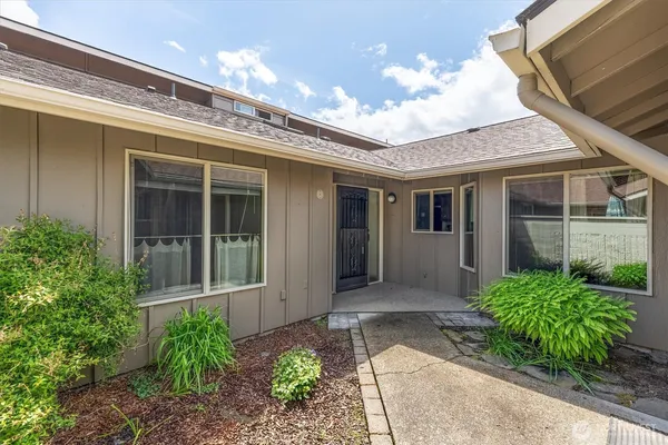 a front view of a house with garden
