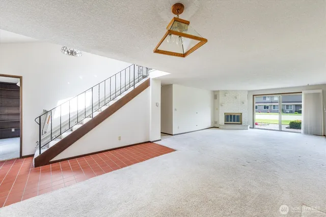 a view of a room with wooden floor and windows