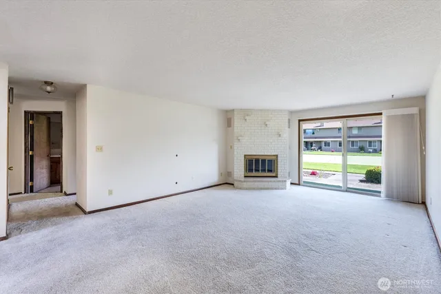 an empty room with furniture and a ceiling fan