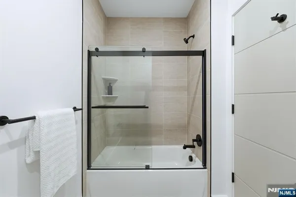 a bathroom with a glass shower door
