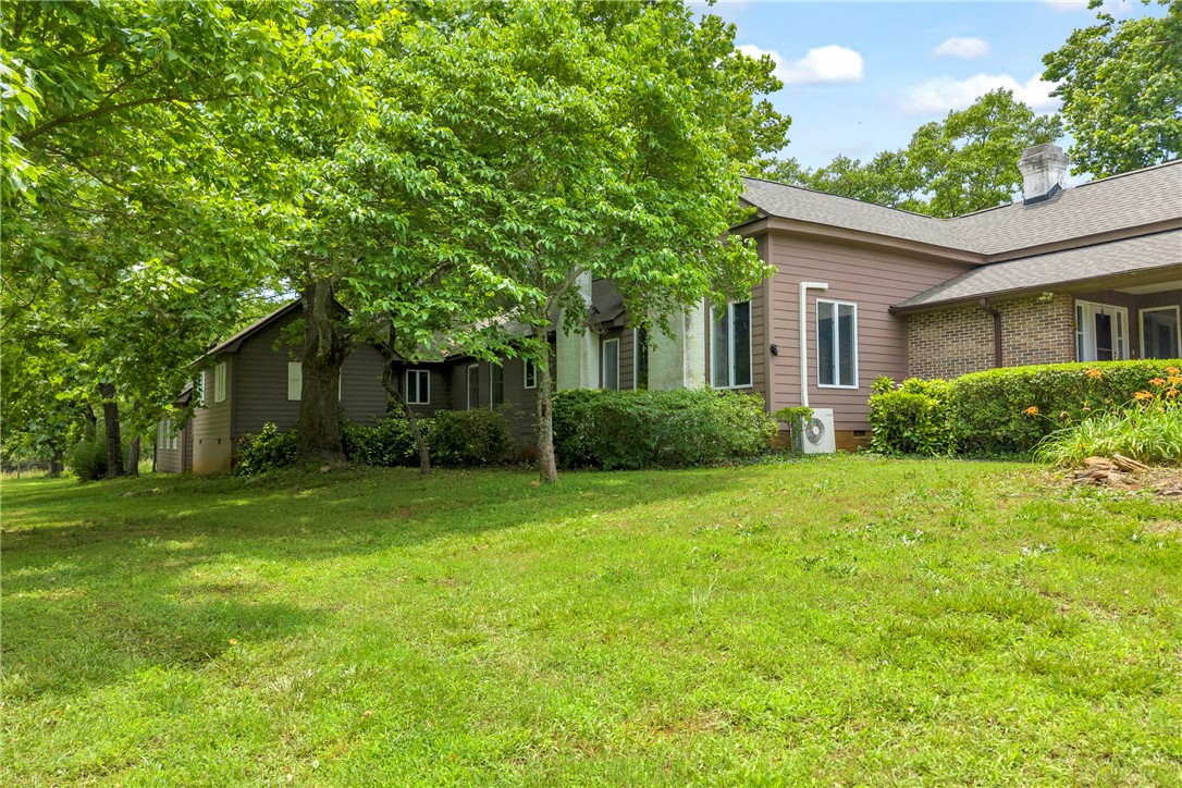 200 Chenault Road Townville, SC 29689 - Photo 47 of 47 A verdant lawn frames the property, shaded by mature trees and featuring a welcoming brick facade.