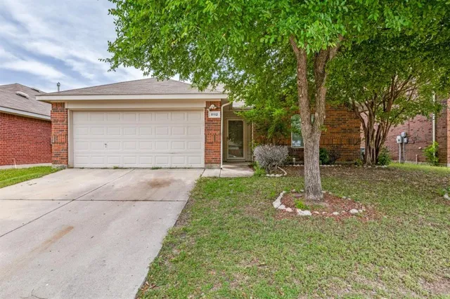 a front view of house with a garden