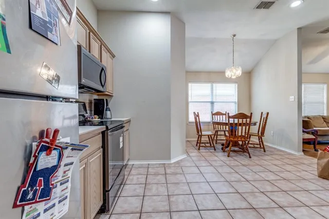a dining room with furniture and a floor to ceiling window
