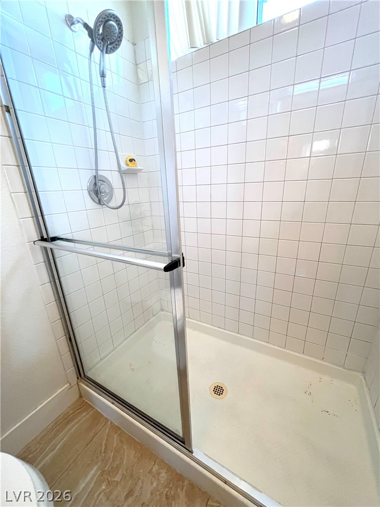 9708 Ridge Creek Place Las Vegas, NV 89134 - Photo 27 of 34 A well-maintained shower with pristine tile work and a convenient glass enclosure.