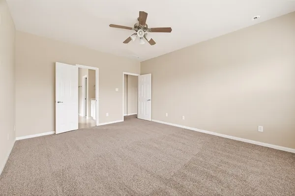 a view of a livingroom with a ceiling fan and window