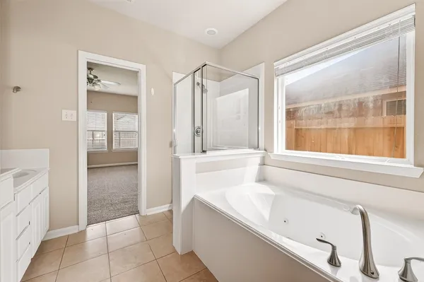 a bathroom with a bathtub and a shower