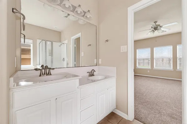 a bathroom with a sink vanity and mirror
