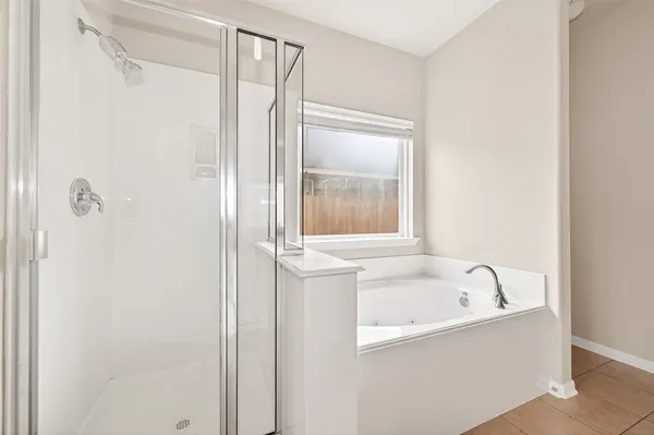 a bathroom with a bathtub and a shower