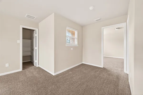 a view of an empty room and closet area