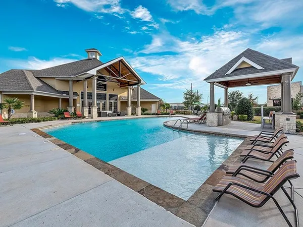 a view of a house with a yard patio and fire pit