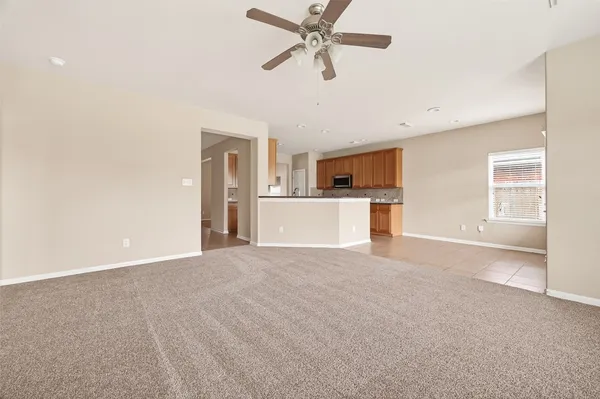 a view of a kitchen with a sink and a refrigerator