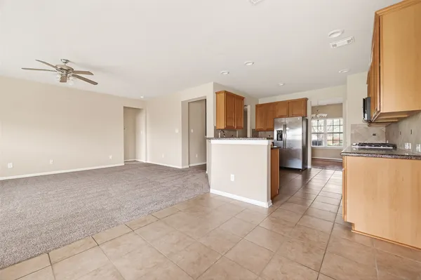 a kitchen with stainless steel appliances a refrigerator and a stove top oven