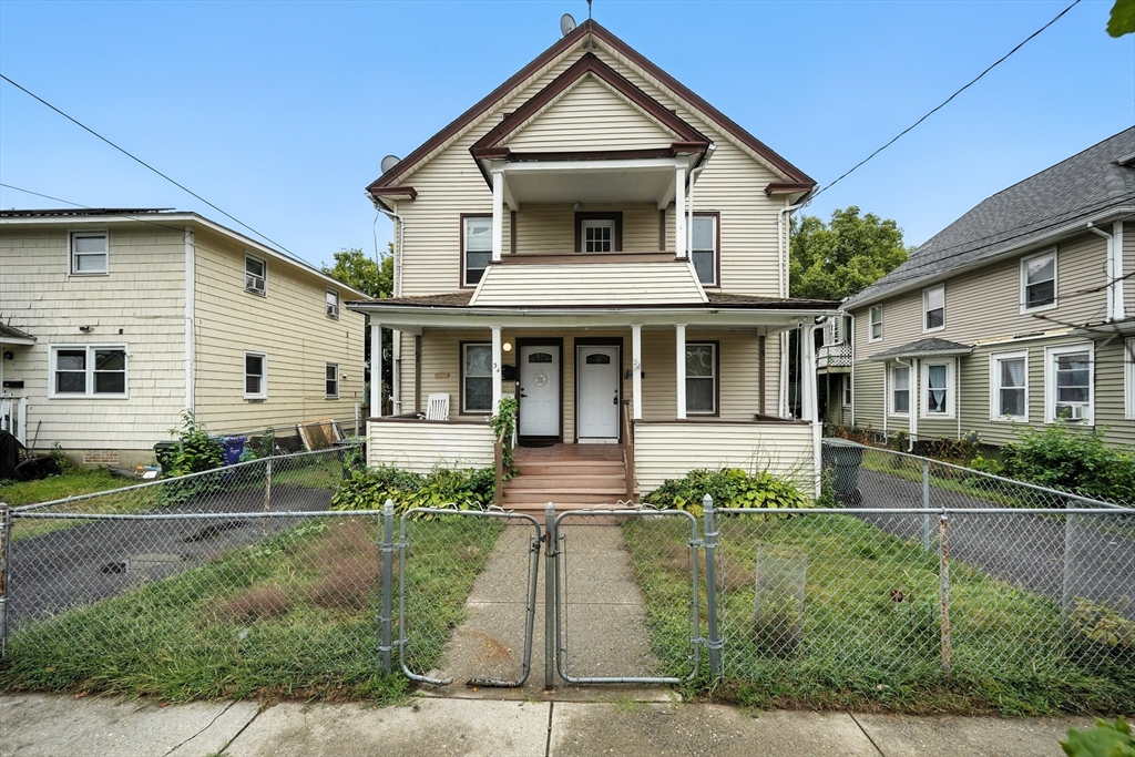 32 Santa Barbara Street, Unit 32 Springfield, MA 01104 - Photo 1 of 21 a front view of a house with a yard