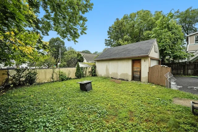 a backyard of a house with plants and trees