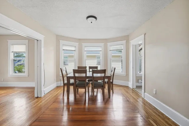 a view of a dining room with furniture and wooden floor