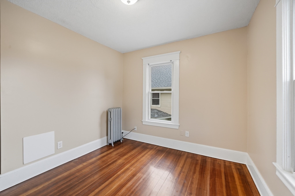 32 Santa Barbara Street, Unit 32 Springfield, MA 01104 - Photo 10 of 21 an empty room with wooden floor and windows
