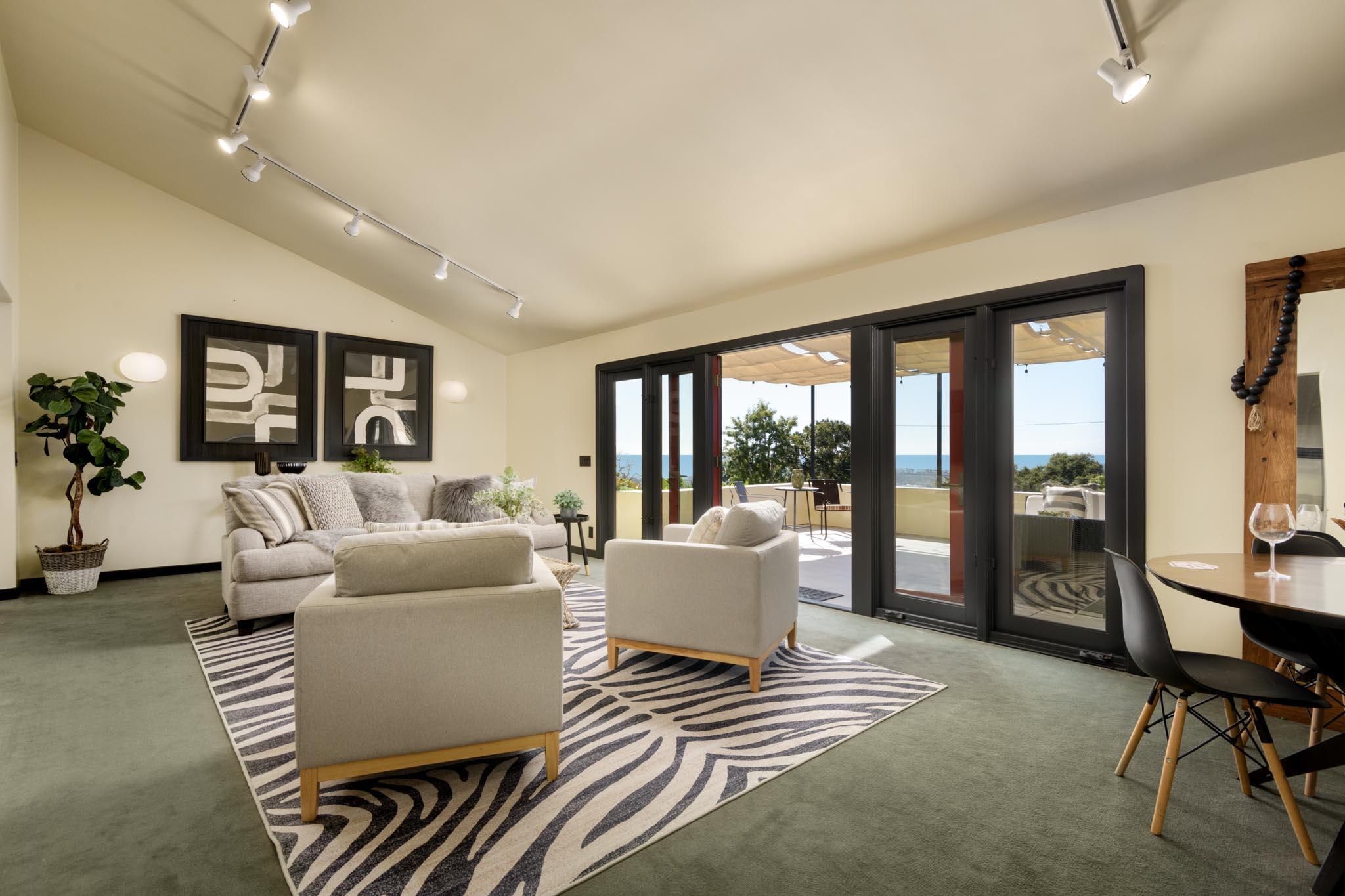 900 Moreno Road Santa Barbara, CA 93103 - Photo 8 of 54 a living room with furniture and large windows