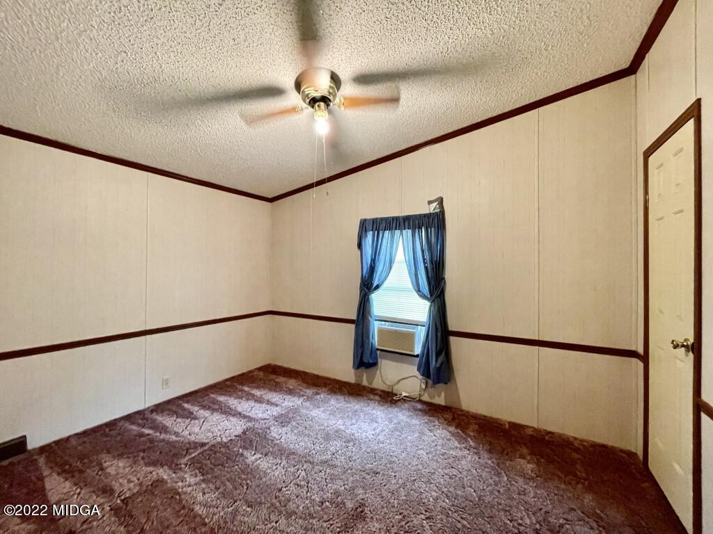 3310 Jackson Road Roberta, GA 31078 - Photo 14 of 26 a view of an empty room with a window and a ceiling fan