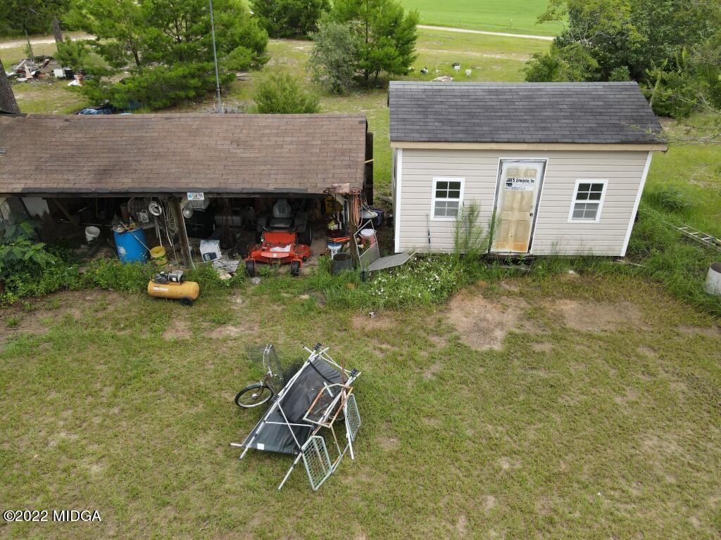 3310 Jackson Road Roberta, GA 31078 - Photo 22 of 26 a backyard of a house with barbeque oven table and chairs