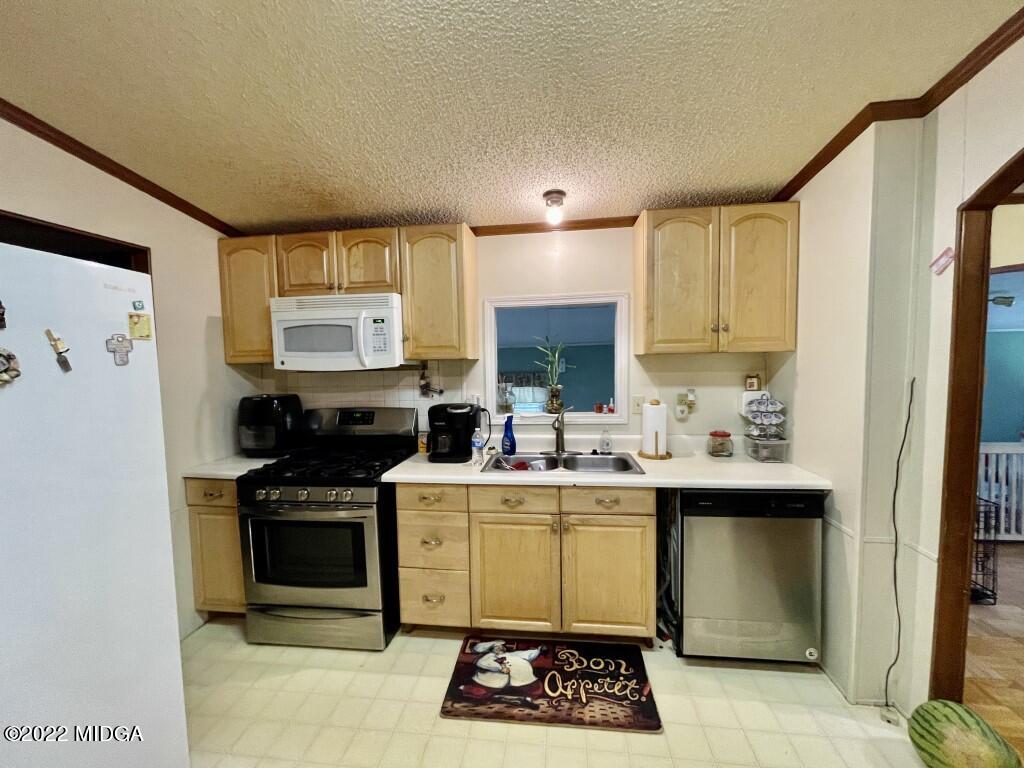 3310 Jackson Road Roberta, GA 31078 - Photo 7 of 26 a kitchen with a sink stainless steel appliances and cabinets