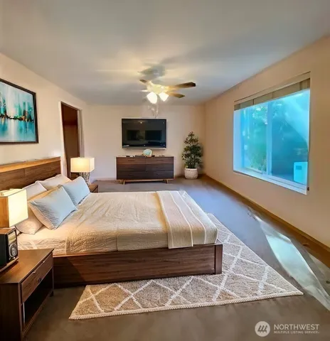 a bedroom with a bed and a flat screen tv