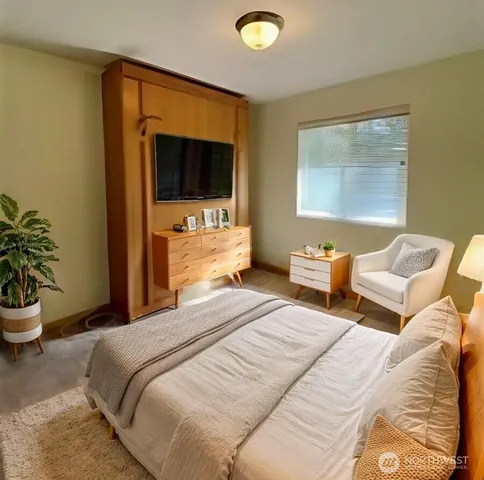 a bedroom with a bed and a flat screen tv