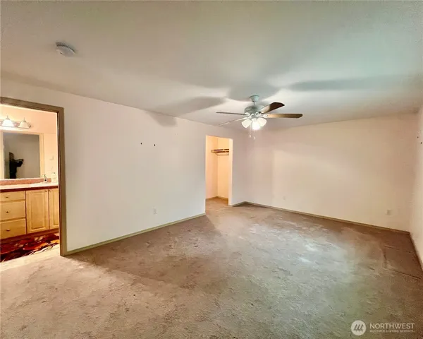 a view of a livingroom with a ceiling fan and window