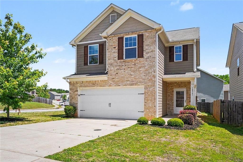 10941 Wheeler Trace Hampton, GA 30228 - Photo 2 of 21 a front view of a house with a yard and garage