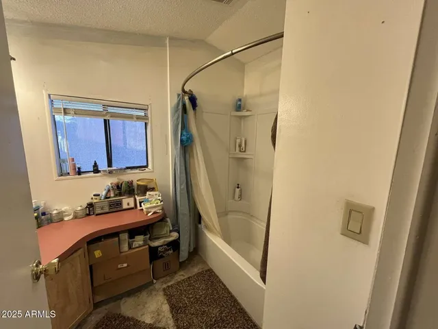 a bathroom with a tub and a mirror