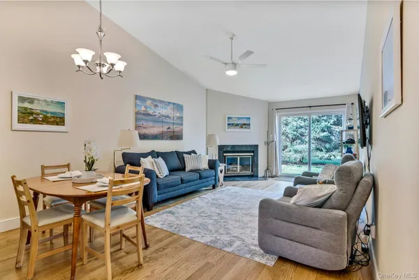 a living room with furniture a chandelier and a window