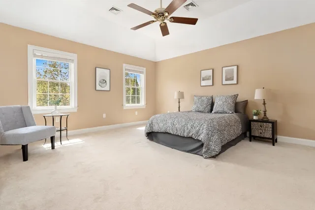 a spacious bedroom with a bed and a chandelier
