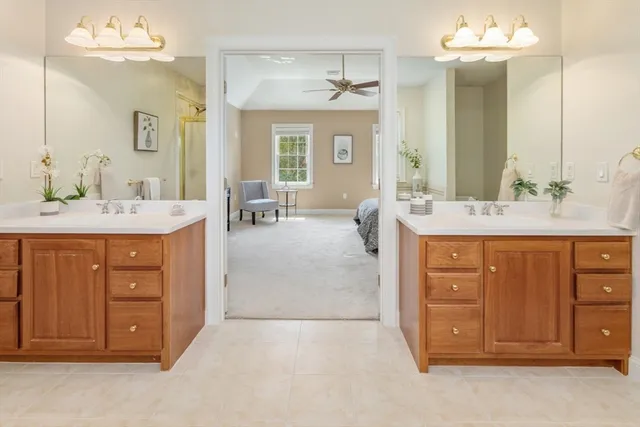 a spacious bathroom with sink shower and bathtub