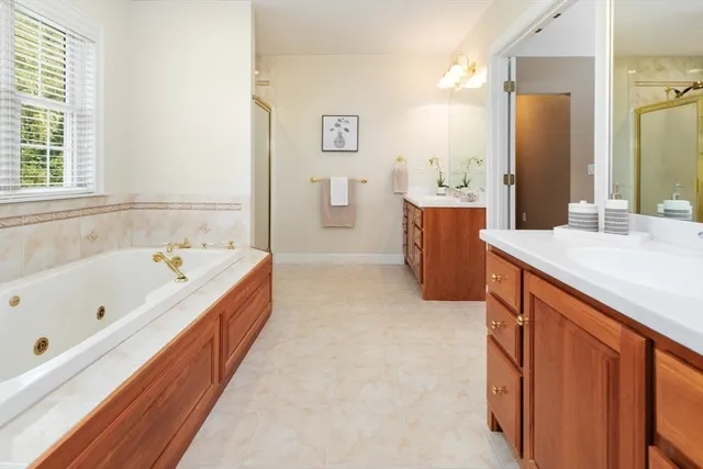 a bathroom with a tub sink and a shower