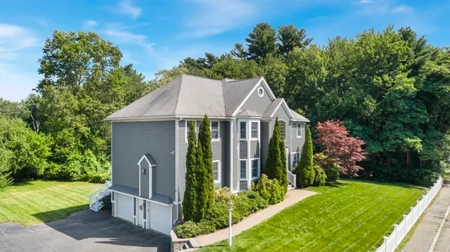 a aerial view of a house with a yard and potted plants