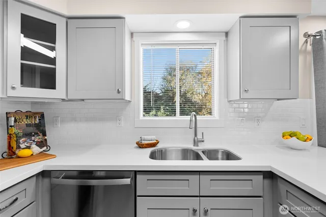 a kitchen with a sink cabinets and window