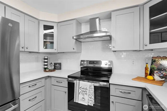 a kitchen with stainless steel appliances granite countertop a stove a cabinets and a refrigerator