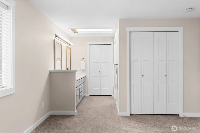 a bathroom with a double vanity sink and a mirror