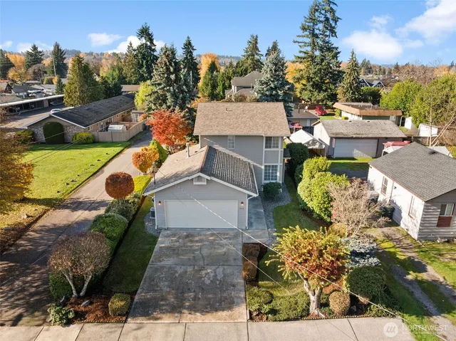 an aerial view of a house with a garden and lake view