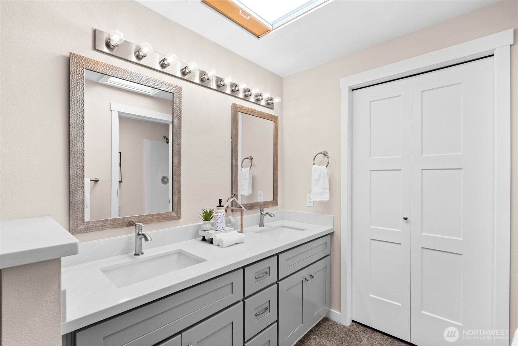 720 7th Street Southwest Puyallup, WA 98371 - Photo 21 of 40 a bathroom with a double vanity sink and a mirror