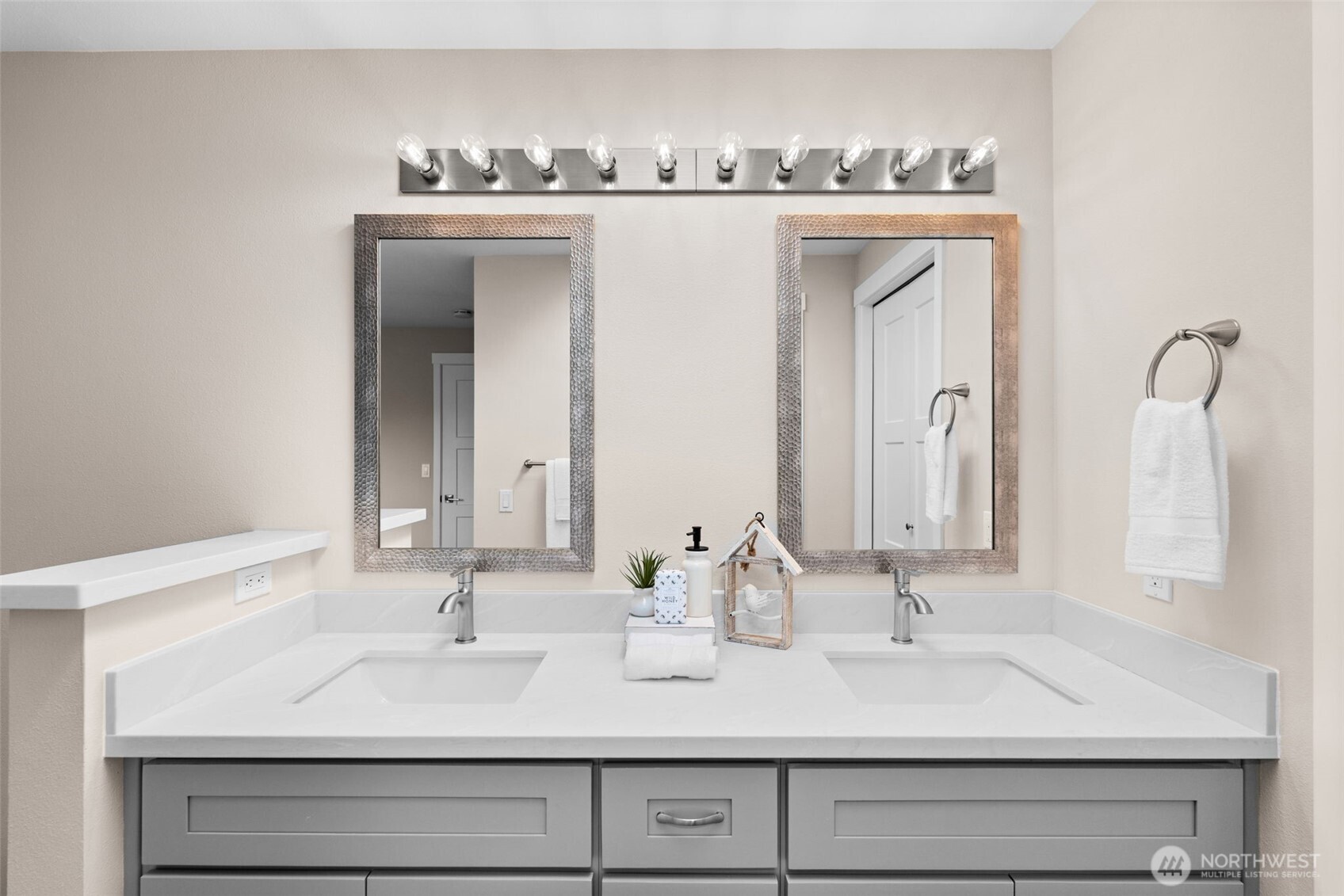 720 7th Street Southwest Puyallup, WA 98371 - Photo 22 of 40 a bathroom with a double vanity sink and a mirror
