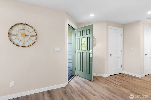 an entryway with wooden floor