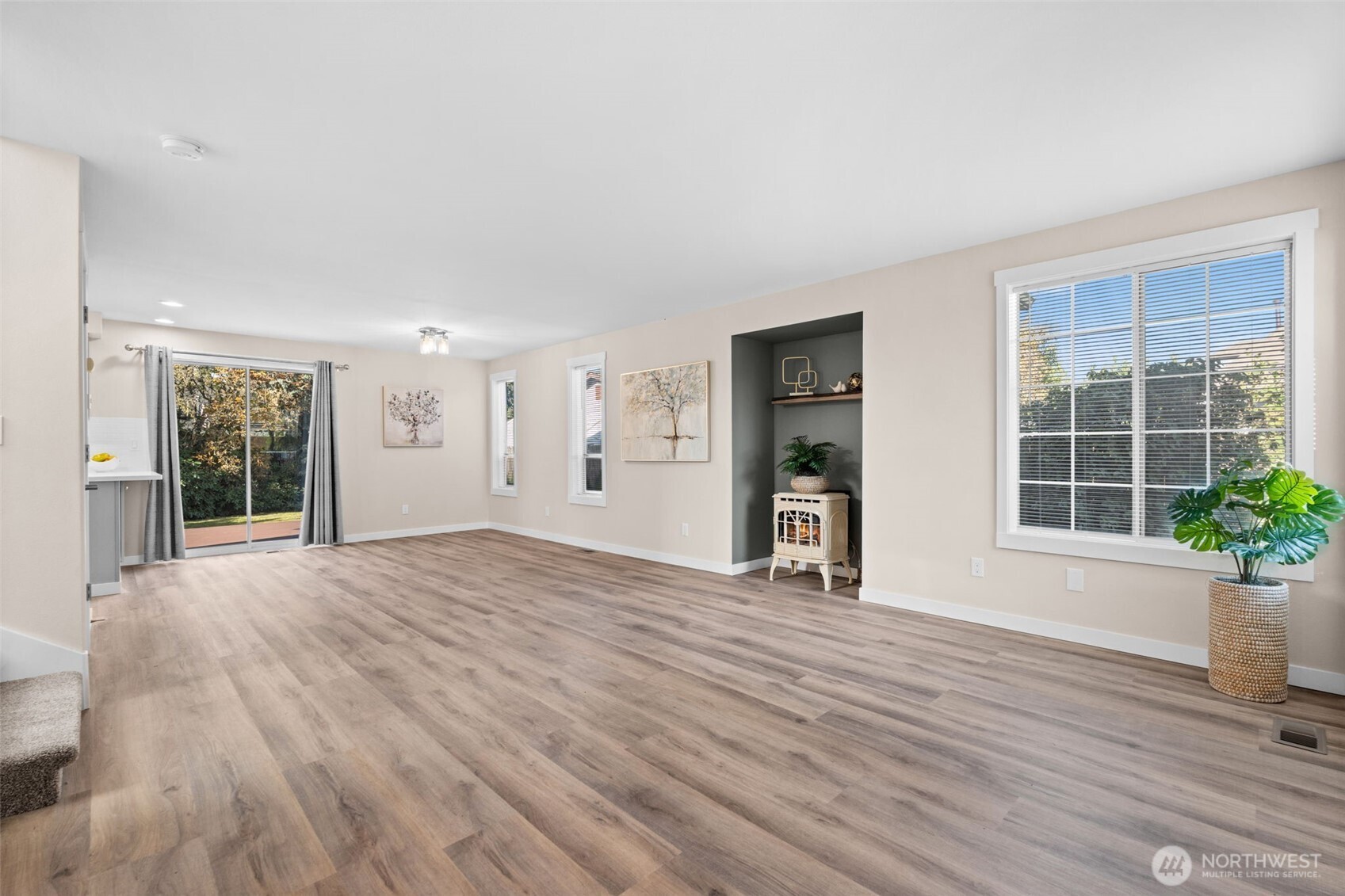 720 7th Street Southwest Puyallup, WA 98371 - Photo 5 of 40 a view of an empty room with wooden floor and a window
